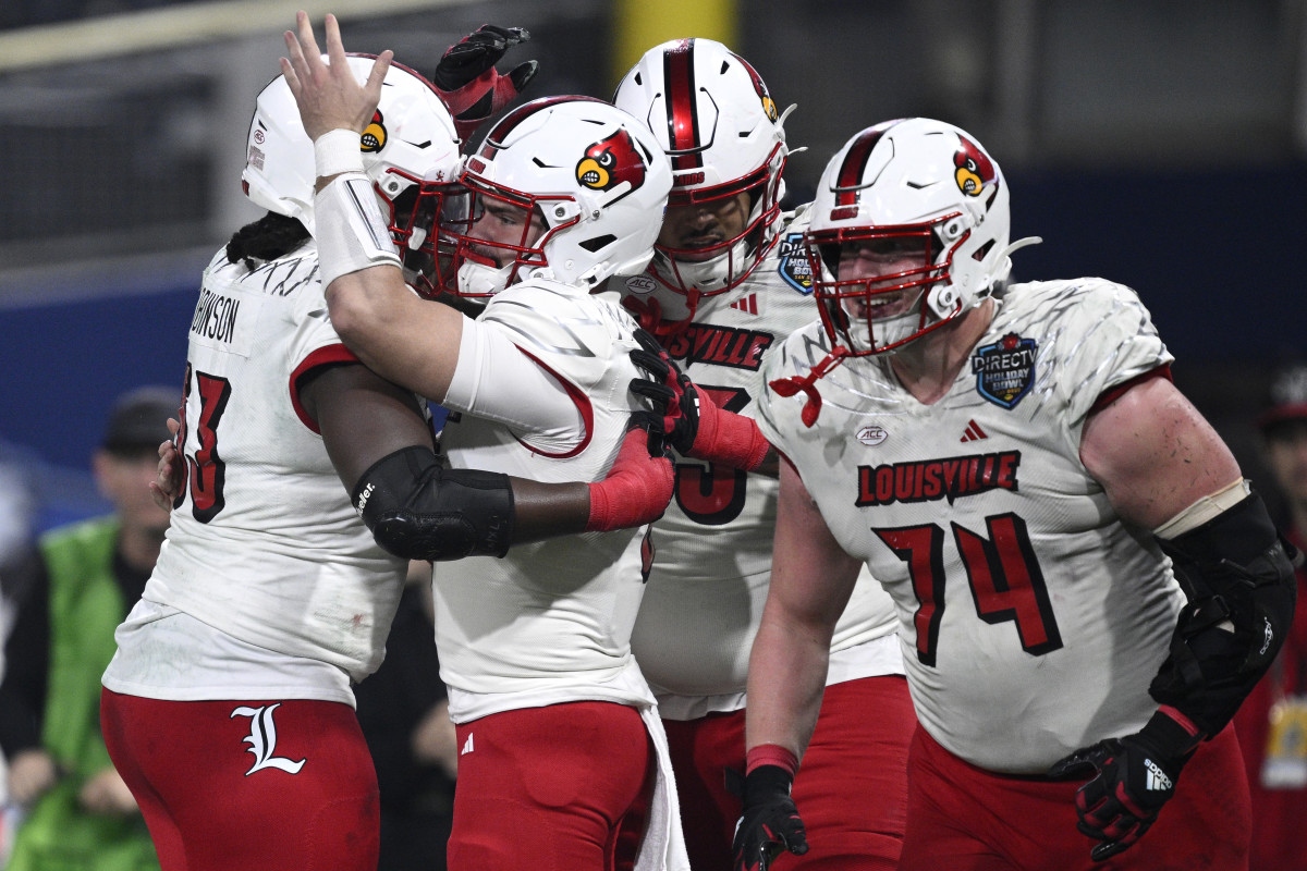 Dec 27, 2023; San Diego, CA, USA; Louisville Cardinals quarterback Evan Conley (6) celebrates with teammates after scoring a touchdown against the USC Trojans during the first half at Petco Park. Mandatory Credit: Orlando Ramirez-USA TODAY Sports